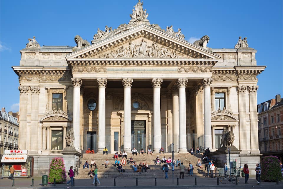 A grand neoclassical building with columns, statues, and intricate carvings.