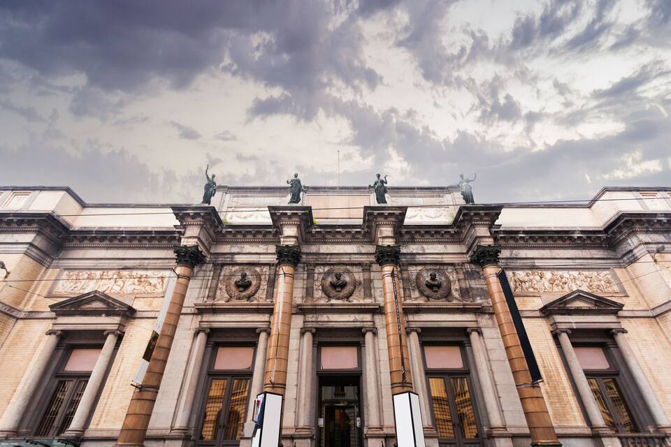 A classical building with ornate columns and statues.