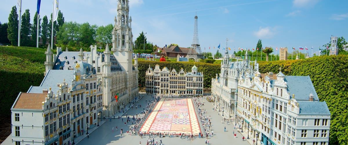 A model of a grand European city square with ornate buildings, a large open plaza, and a model Eiffel Tower in the background.
