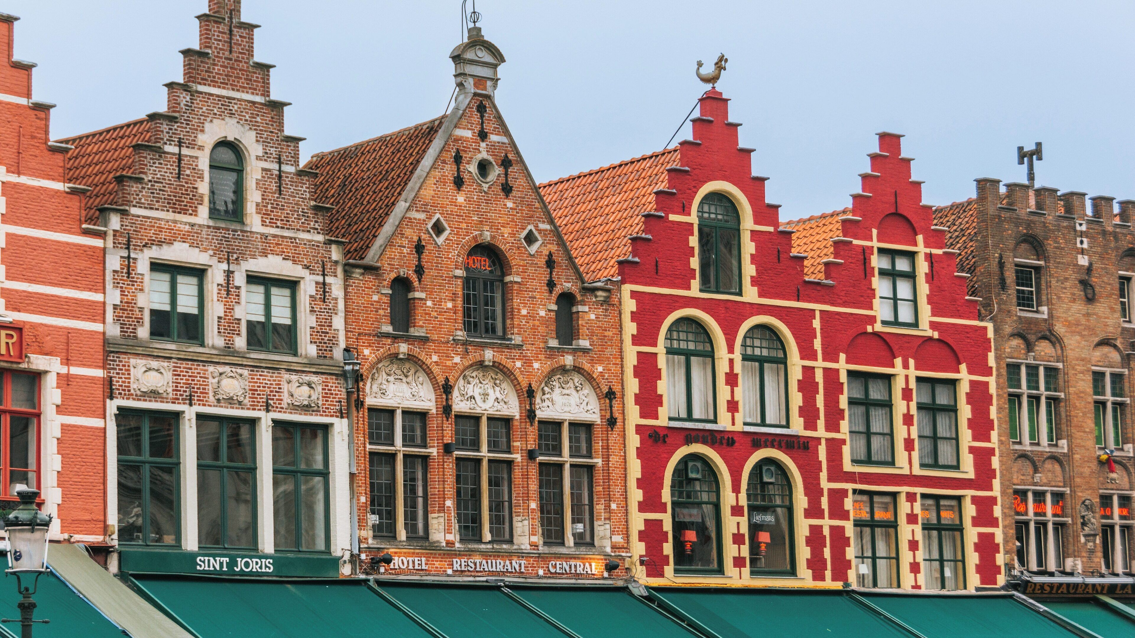 Exploring Bruges Market Square with its vibrant historic architecture in the heart of the Flemish Region, Belgium