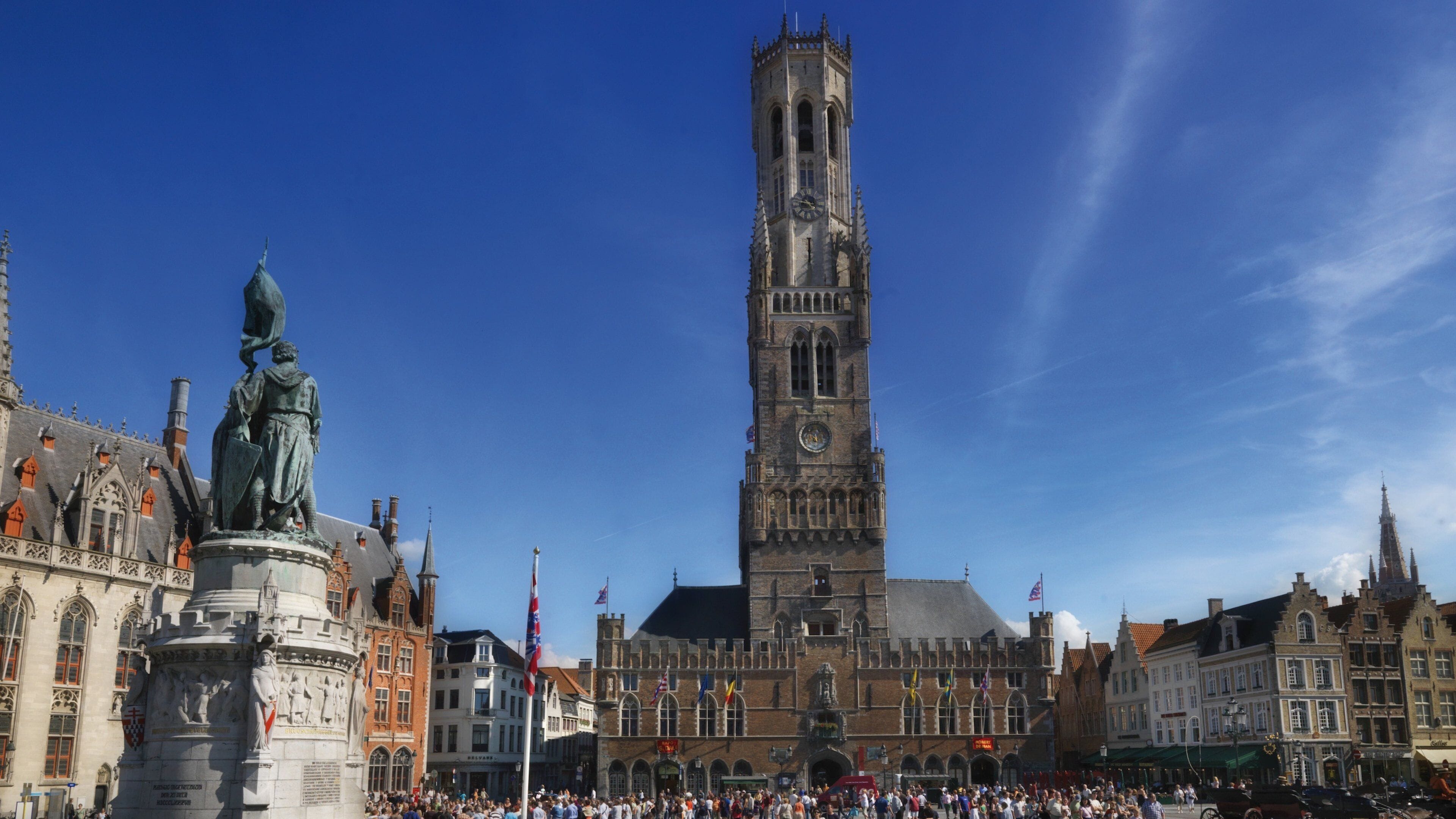 Bruges Belfry featuring heritage architecture and a city as well as a large group of people