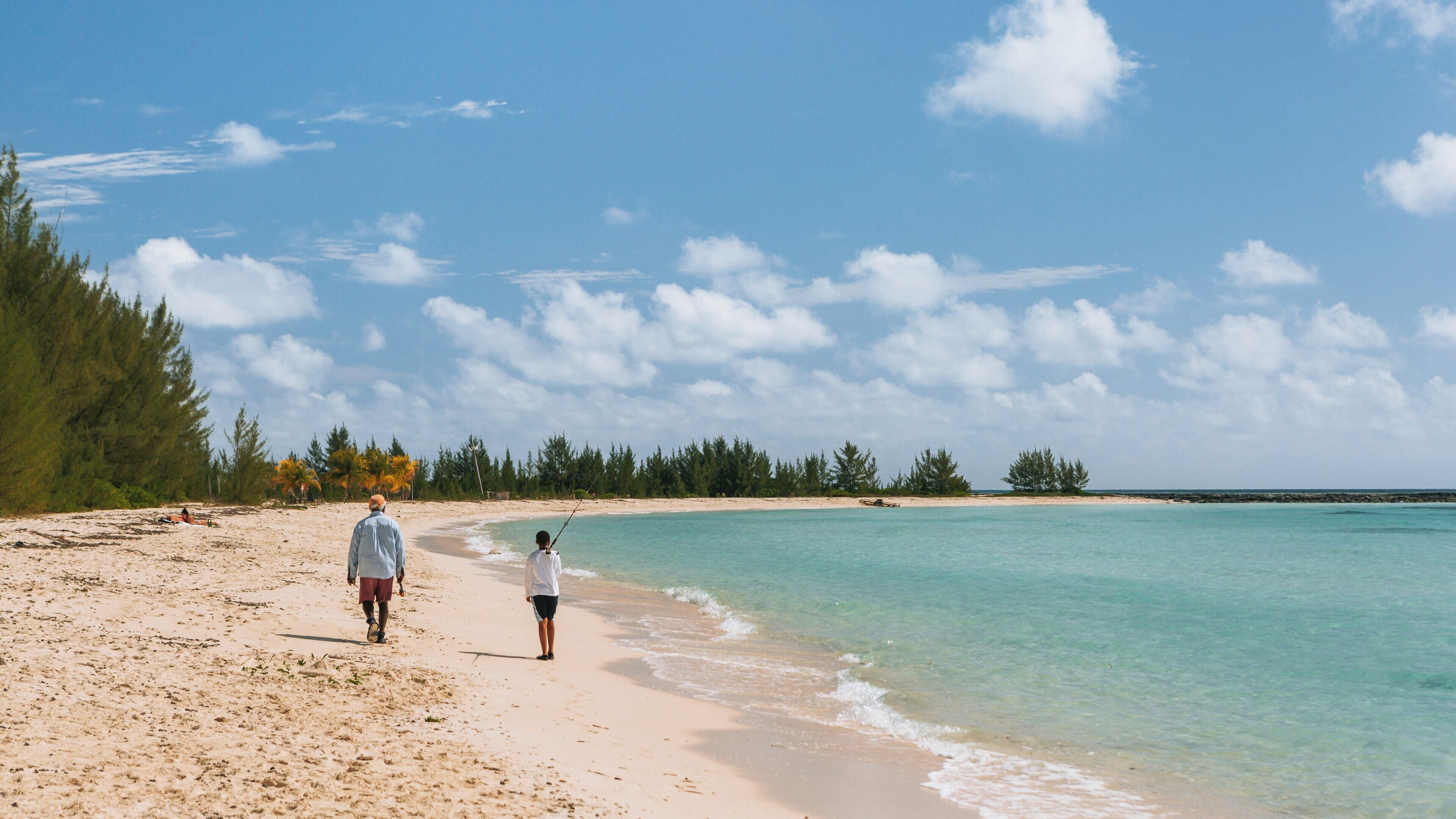 Enjoying a sunny day at Xanadu Beach in Freeport, West Grand Bahama with fishing activities along the shoreline