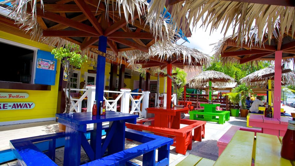 A colorful outdoor seating area with thatched umbrellas and vibrant furniture.