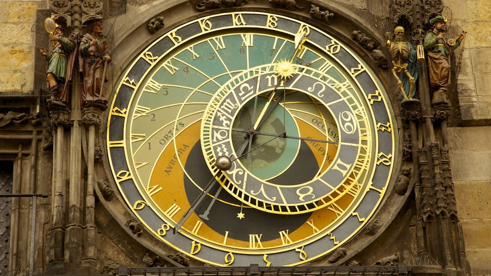 A detailed astronomical clock with Roman numerals and zodiac signs.