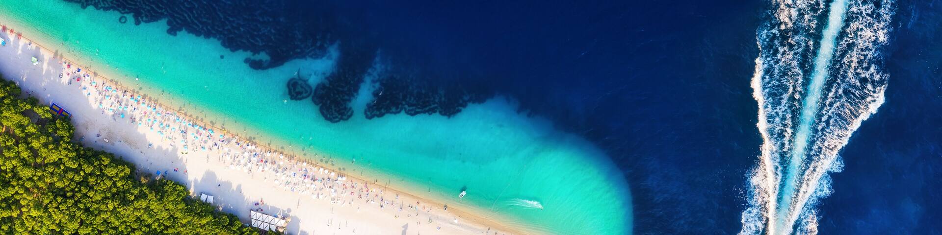 Croatia, Hvar island, Bol. Aerial view at the Zlatni Rat. Aerial view of luxury floating boat on blue Adriatic sea at sunny day. Travel - image