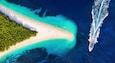 Croatia, Hvar island, Bol. Aerial view at the Zlatni Rat. Aerial view of luxury floating boat on blue Adriatic sea at sunny day. Travel - image