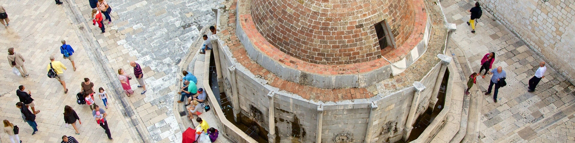 Onofrio\'s Fountain featuring heritage architecture as well as a large group of people