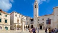 Sponza Palace showing heritage architecture and a square or plaza as well as a small group of people