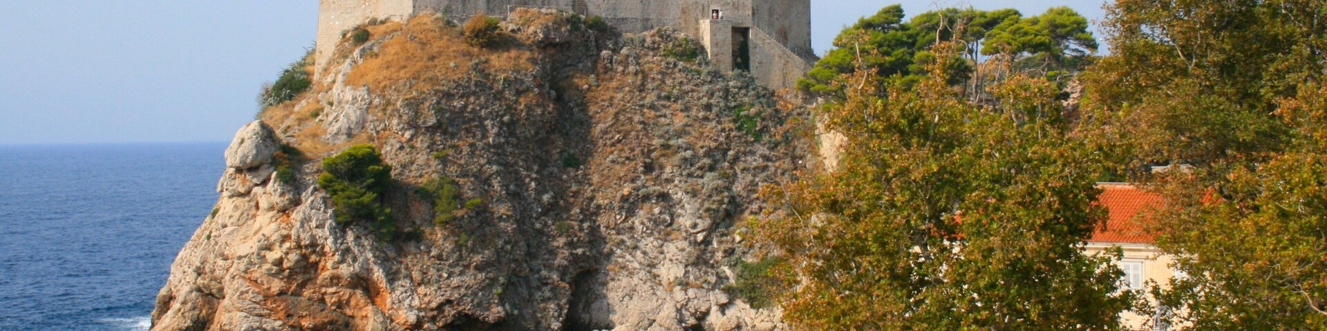 Revelin Fortress featuring chateau or palace, heritage architecture and rocky coastline