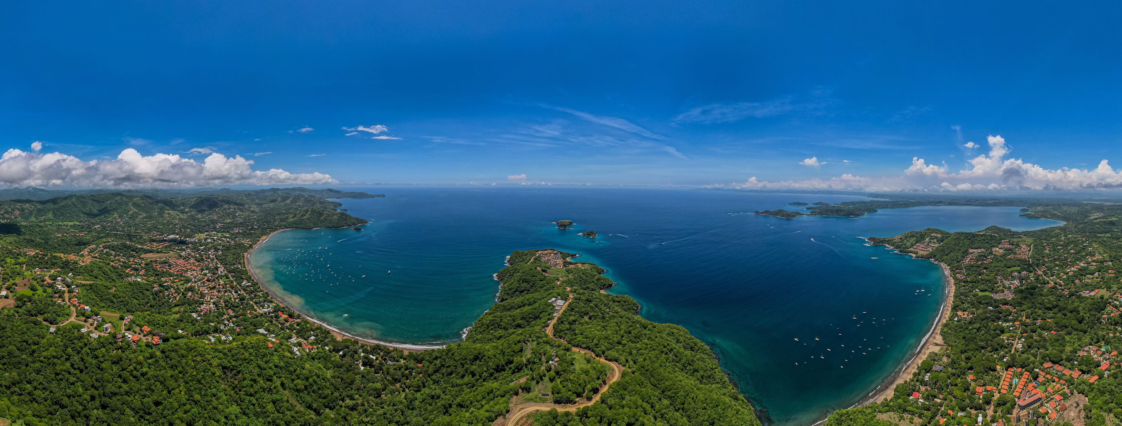 Beautiful aerial view of Playas del Coco, Hermosa Beach and its green mountains, bay and yachts in Costa Rica