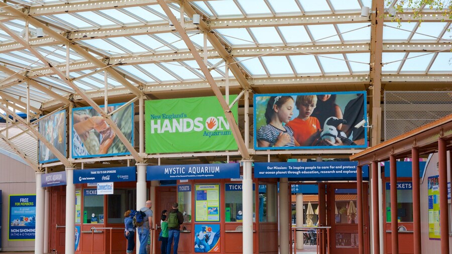 Mystic Aquarium and Institute for Exploration featuring marine life and signage as well as a family
