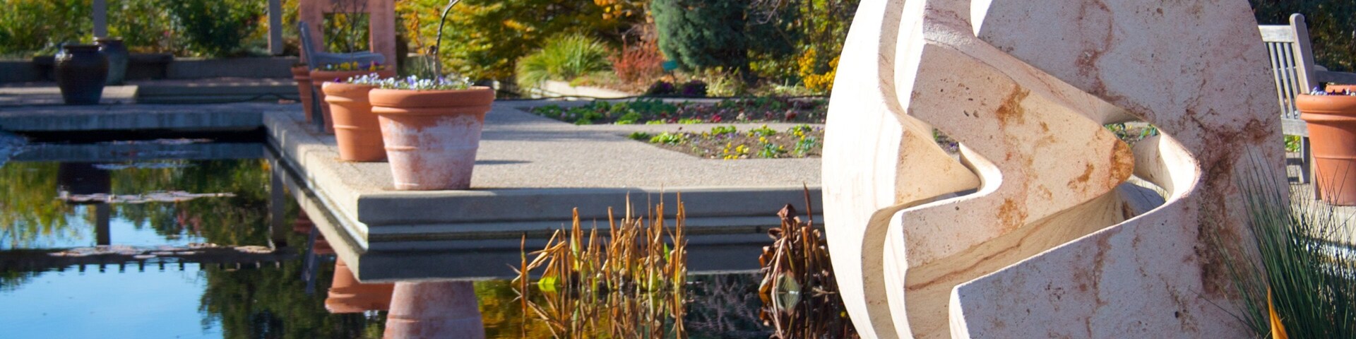 Vibrant fall colors reflect in tranquil waters at Denver Botanic Gardens