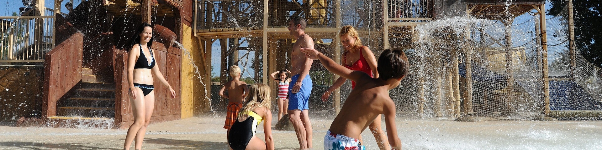Elitch Gardens Theme Park featuring a pool and a waterpark as well as a small group of people