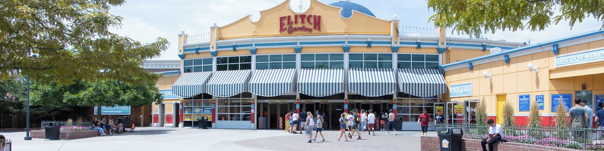 A large, yellow building with a blue dome and striped awnings, labeled "ELITCHUR Gardens."