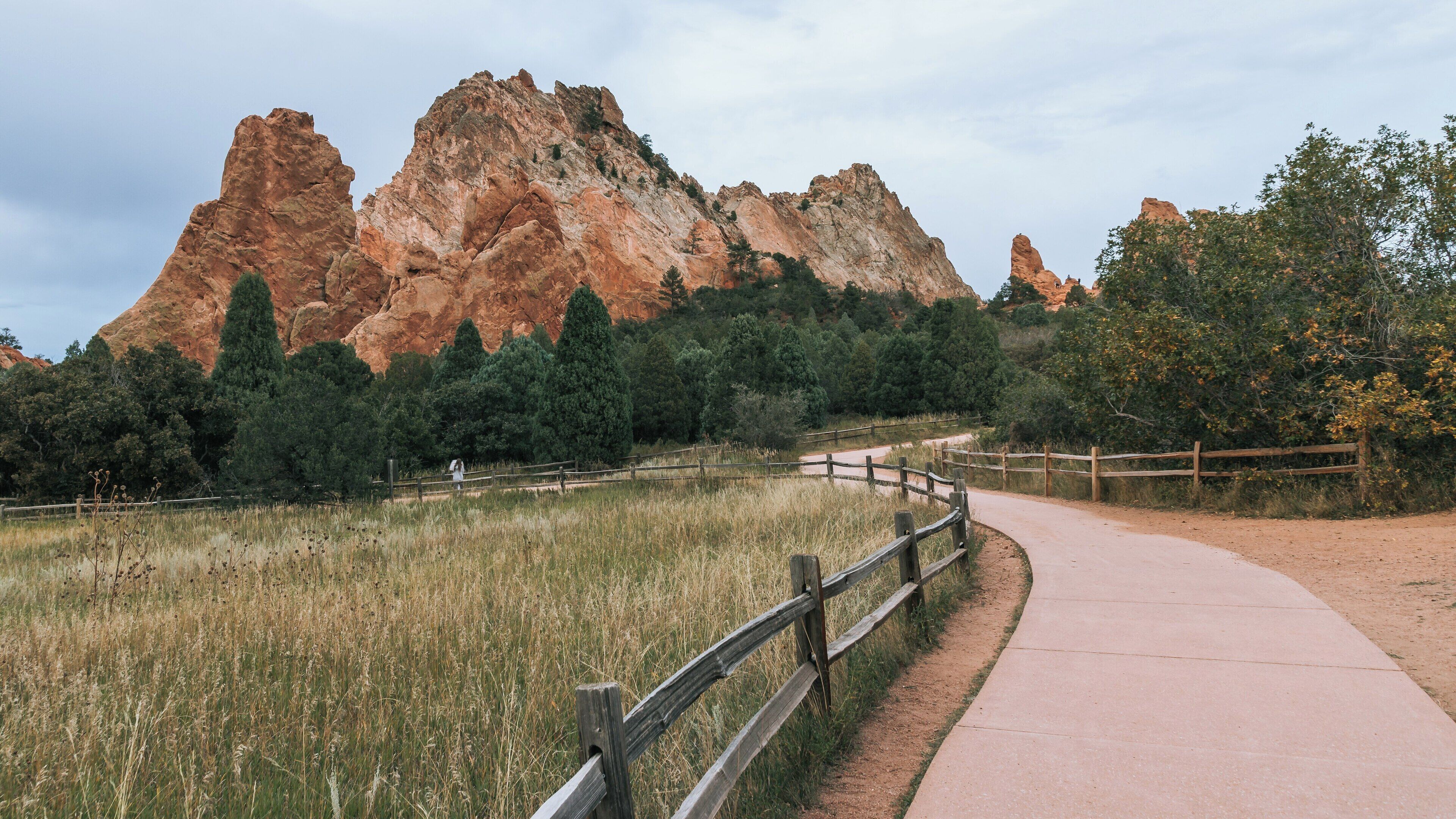 Scenic pathway through the stunning Garden of the Gods with distinctive red rock formations and lush greenery in Colorado Springs