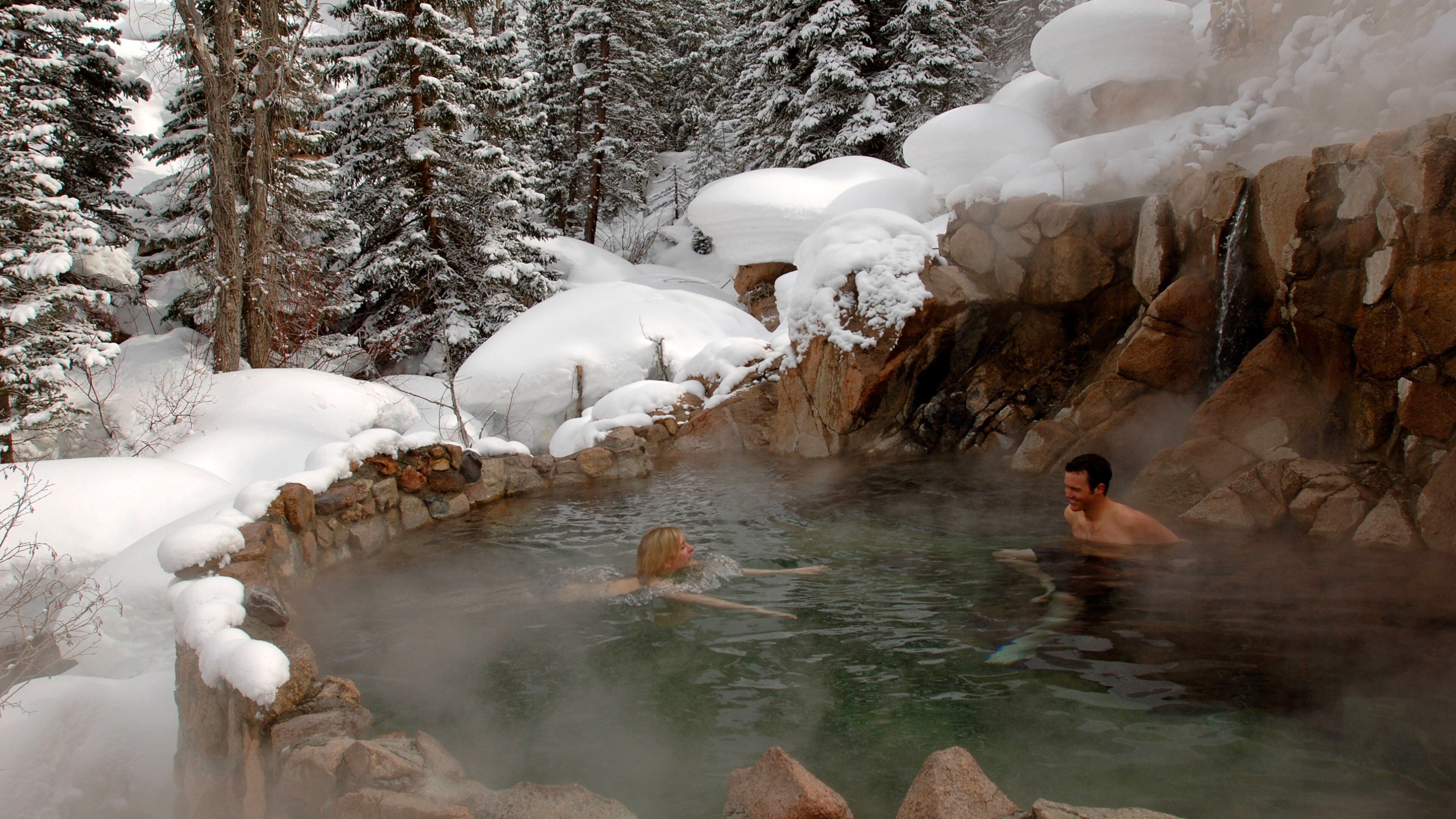 Steamboat Ski Resort which includes snow and a hot spring as well as a small group of people
