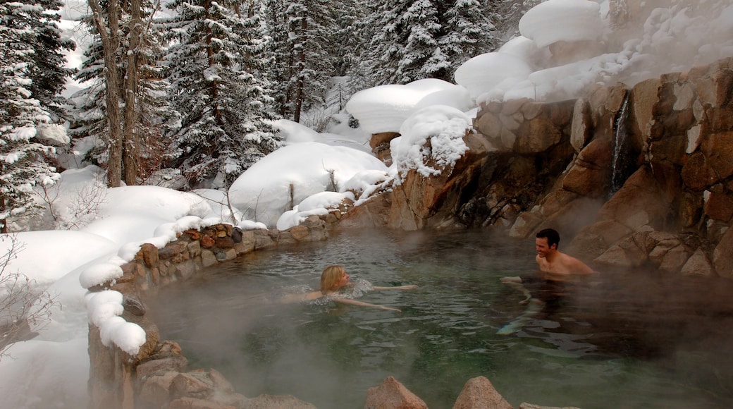 Steamboat Ski Resort which includes snow and a hot spring as well as a small group of people