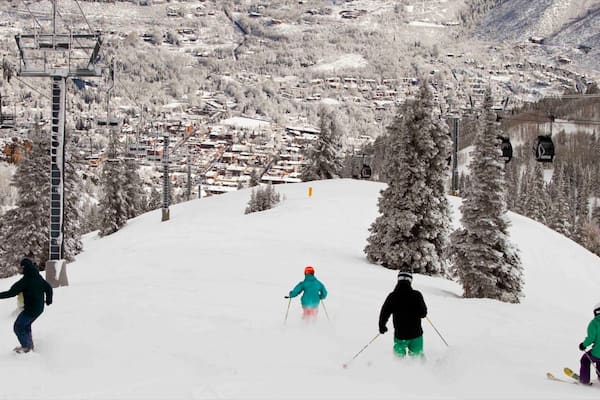 Aspen Mountain which includes a small town or village, snow boarding and snow skiing