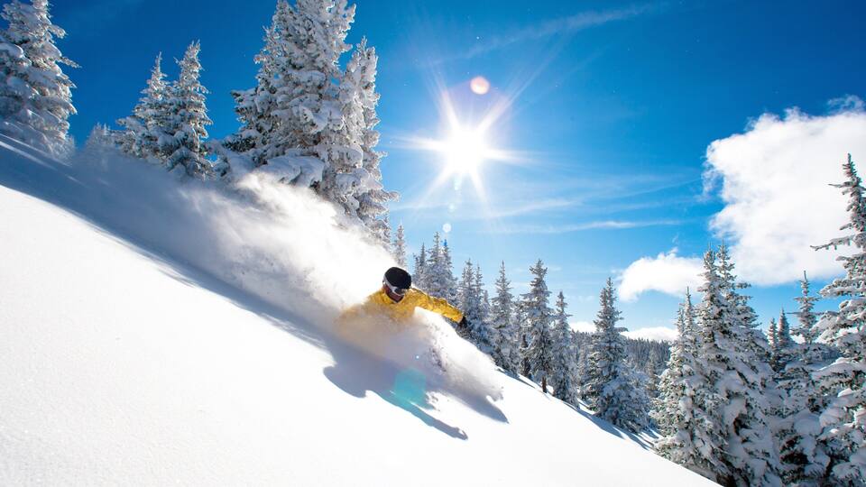 Vail Ski Resort which includes snow skiing and snow as well as an individual male