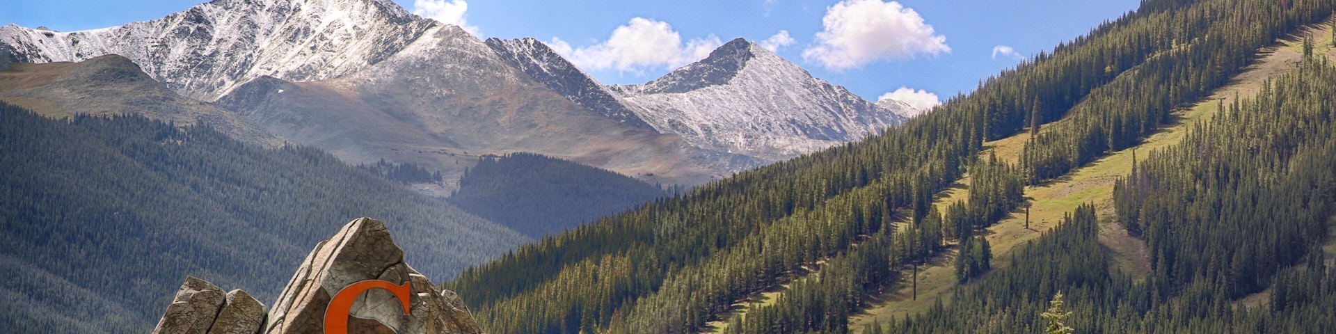 A mountain landscape with a large rock featuring the text "Copper Mountain".