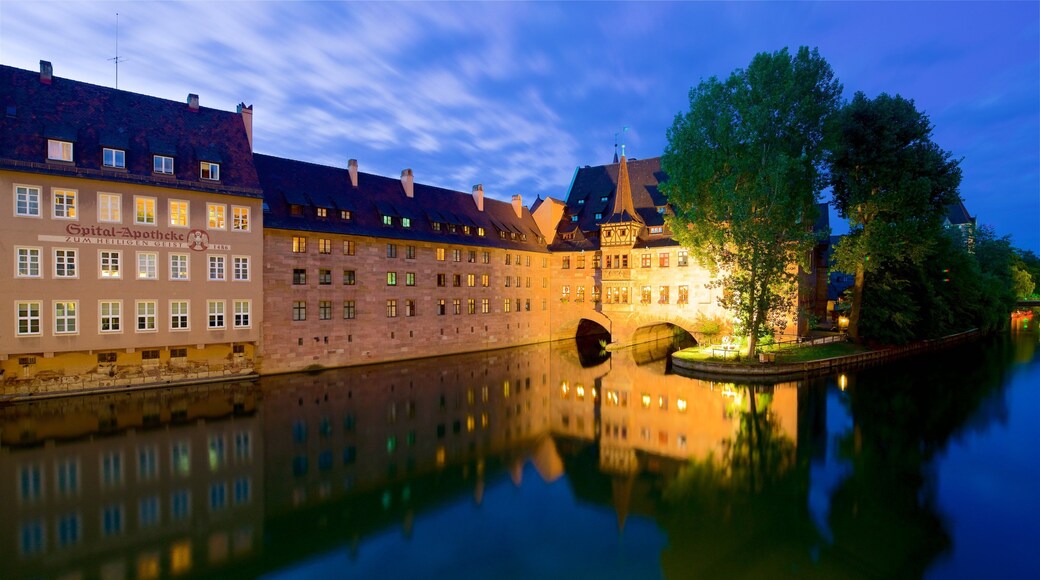 Heilig Geist Spital which includes heritage elements, a river or creek and a sunset