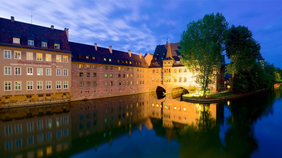 Heilig Geist Spital which includes heritage elements, a river or creek and a sunset
