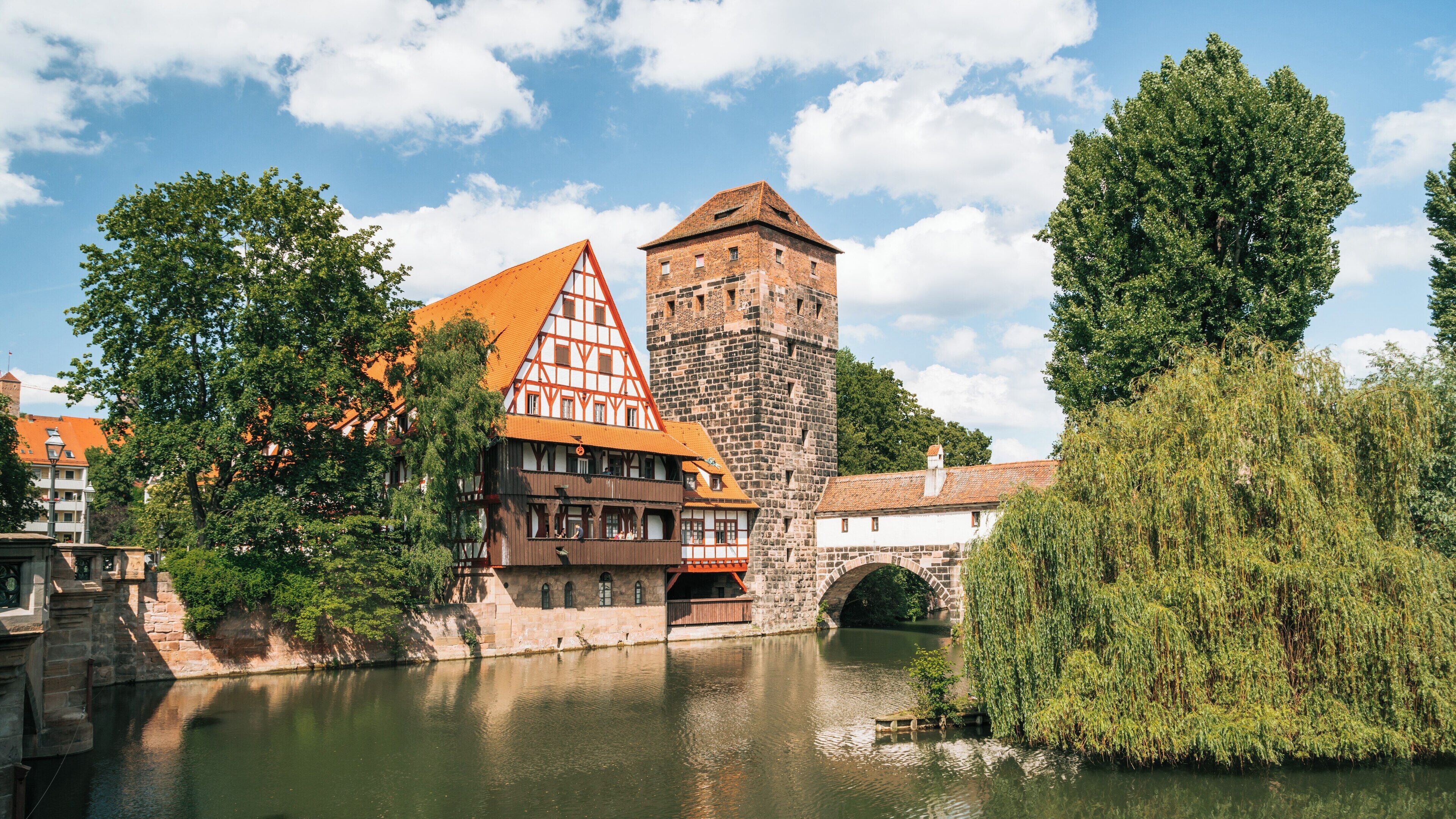 Exploring Max Bridge in Nuremberg Old Town surrounded by historic architecture and serene waters in Bavaria, Germany