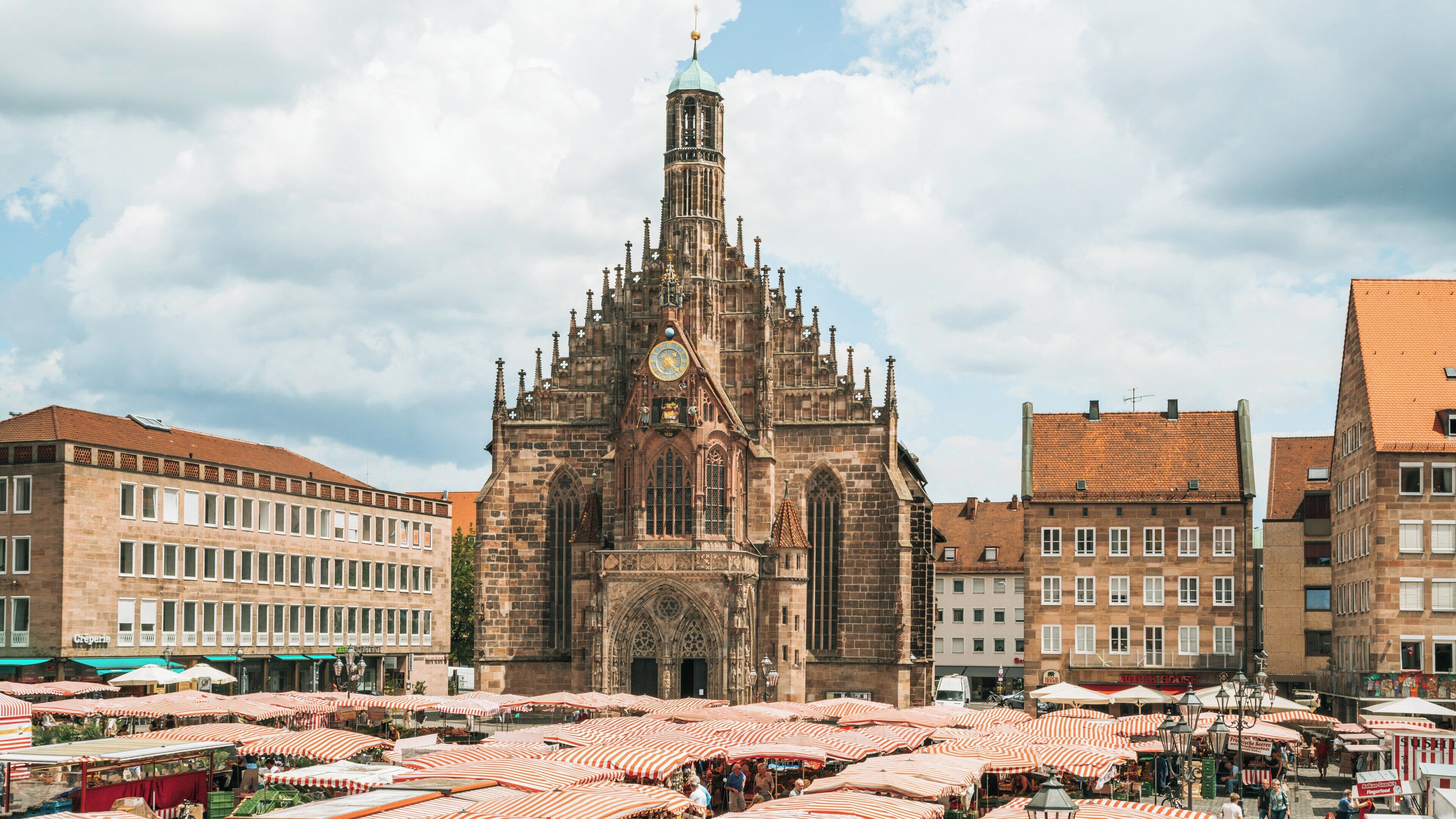 Exploring Main Market Square in Nuremberg's Old Town with vibrant market stalls and historic architecture