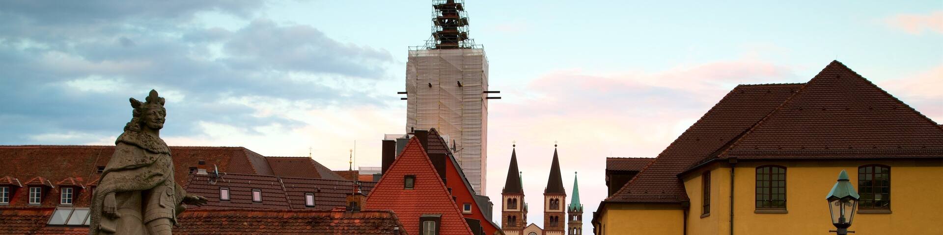 Alte Mainbruecke which includes a sunset, a statue or sculpture and heritage elements