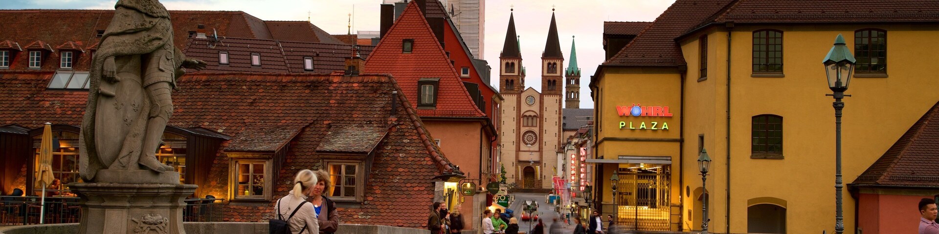 Alte Mainbruecke which includes a sunset, a statue or sculpture and heritage elements