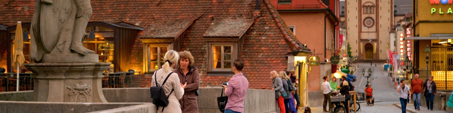 Alte Mainbruecke featuring a statue or sculpture and heritage elements as well as a small group of people