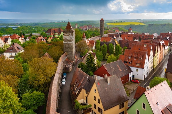 Great aerial view of Rothenburg ob der Tauber, a town in the Franconia region of Bavaria, Germany. The medieval town fortification shows the outer walls and the towers at intervals along the wall.