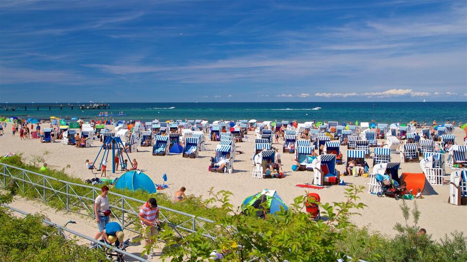 A crowded beach with numerous striped beach chairs and tents.