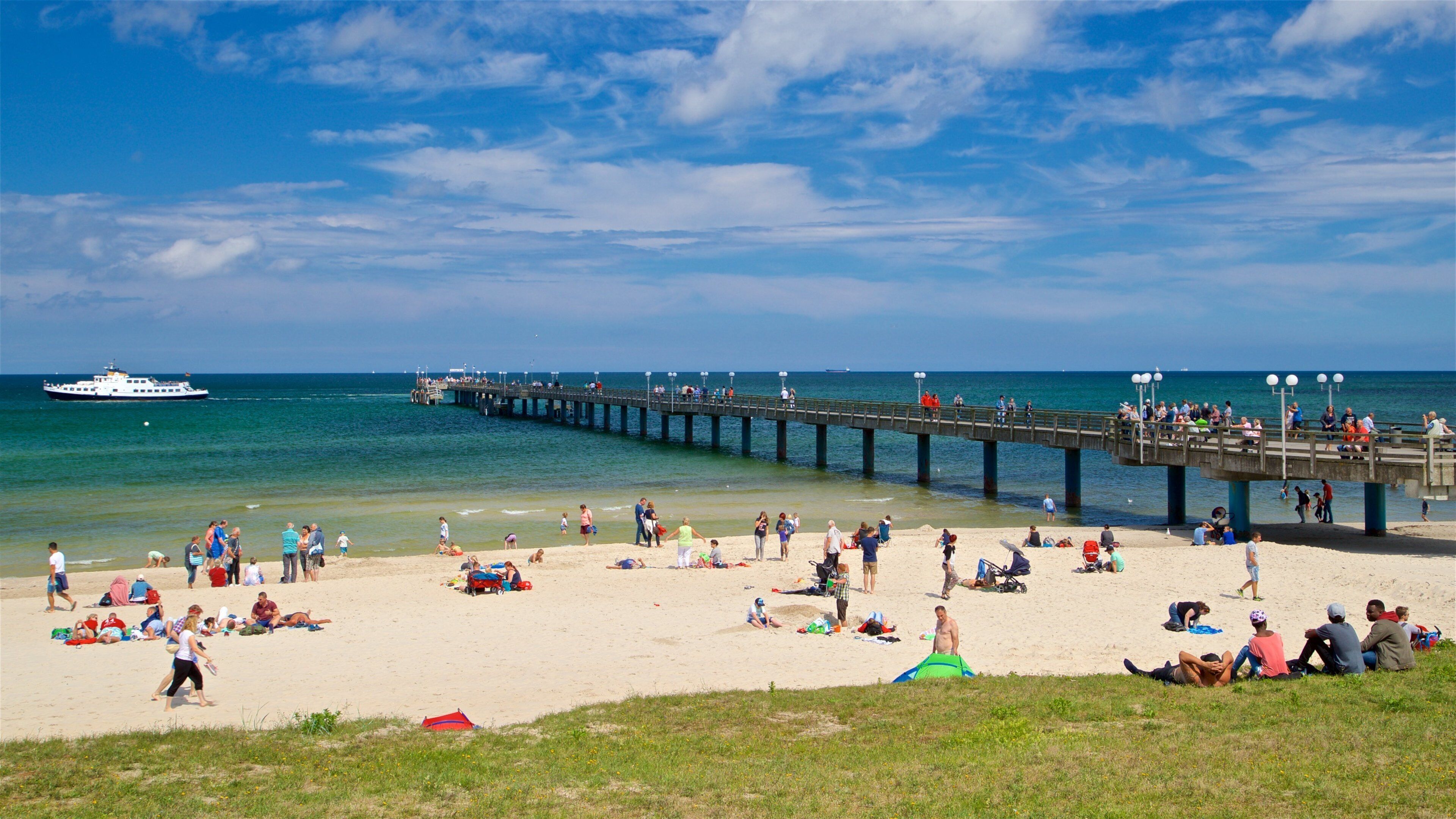 Binz Beach showing a beach and general coastal views as well as a small group of people