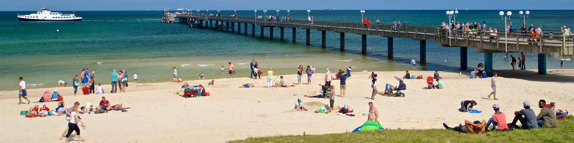 Binz Beach showing a beach and general coastal views as well as a small group of people