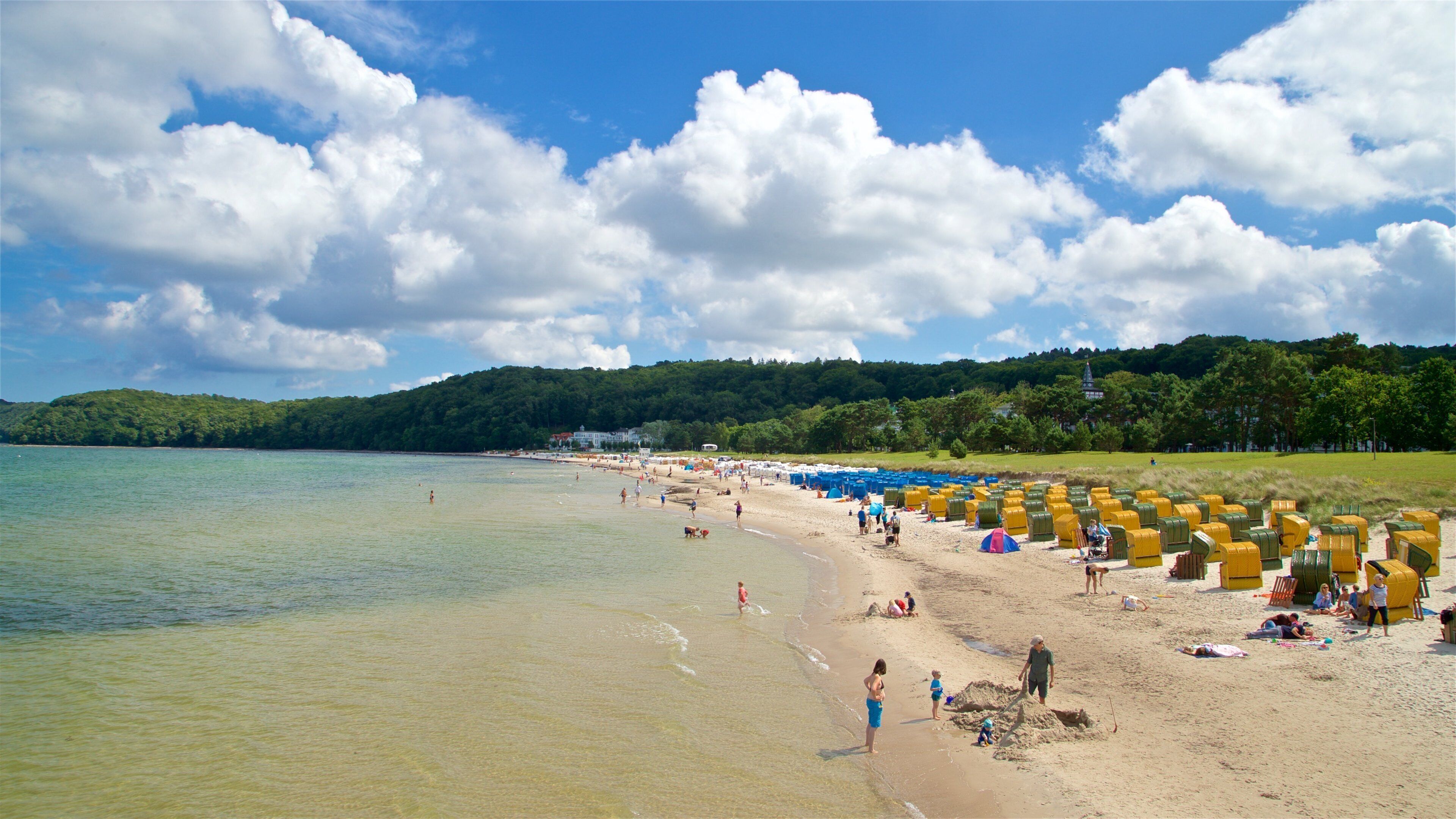 Binz Beach which includes general coastal views and a sandy beach as well as a small group of people