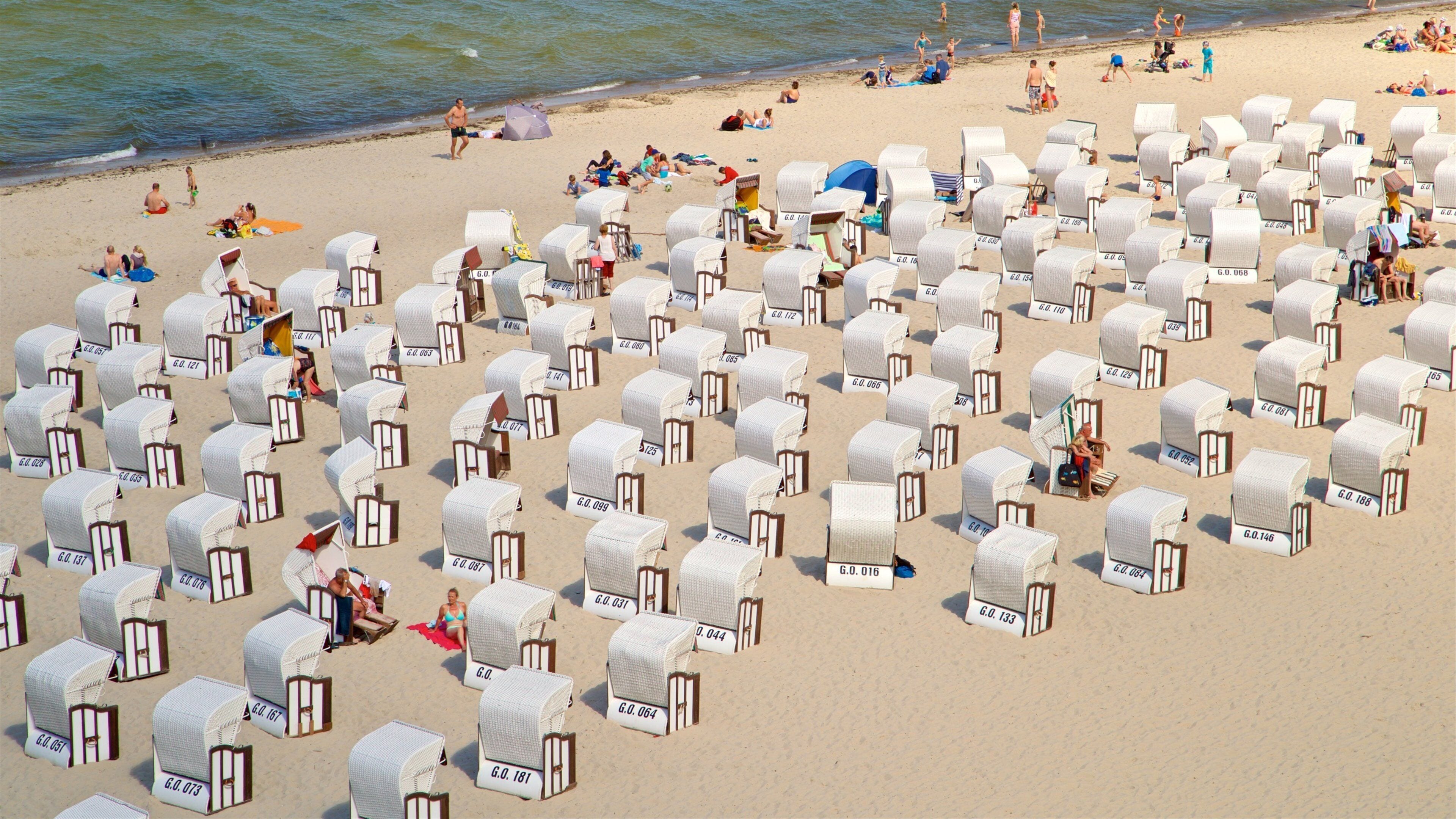 Sellin Pier featuring a beach and general coastal views as well as a small group of people