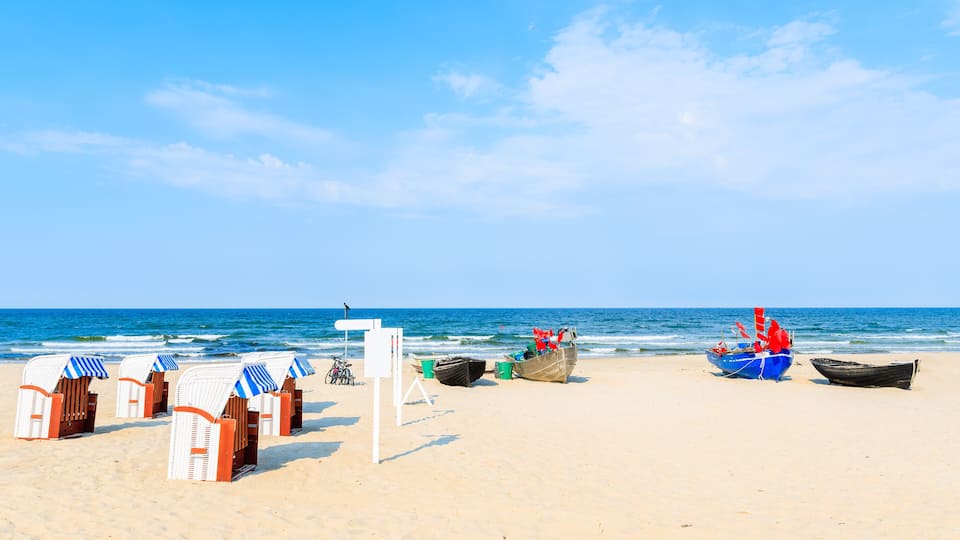 Traditional wooden chairs and fishing boats on sandy beach in Baabe summer resort, Ruegen island, Baltic Sea, Germany, Shutterstock ID 1106251097, Purchase Order: -