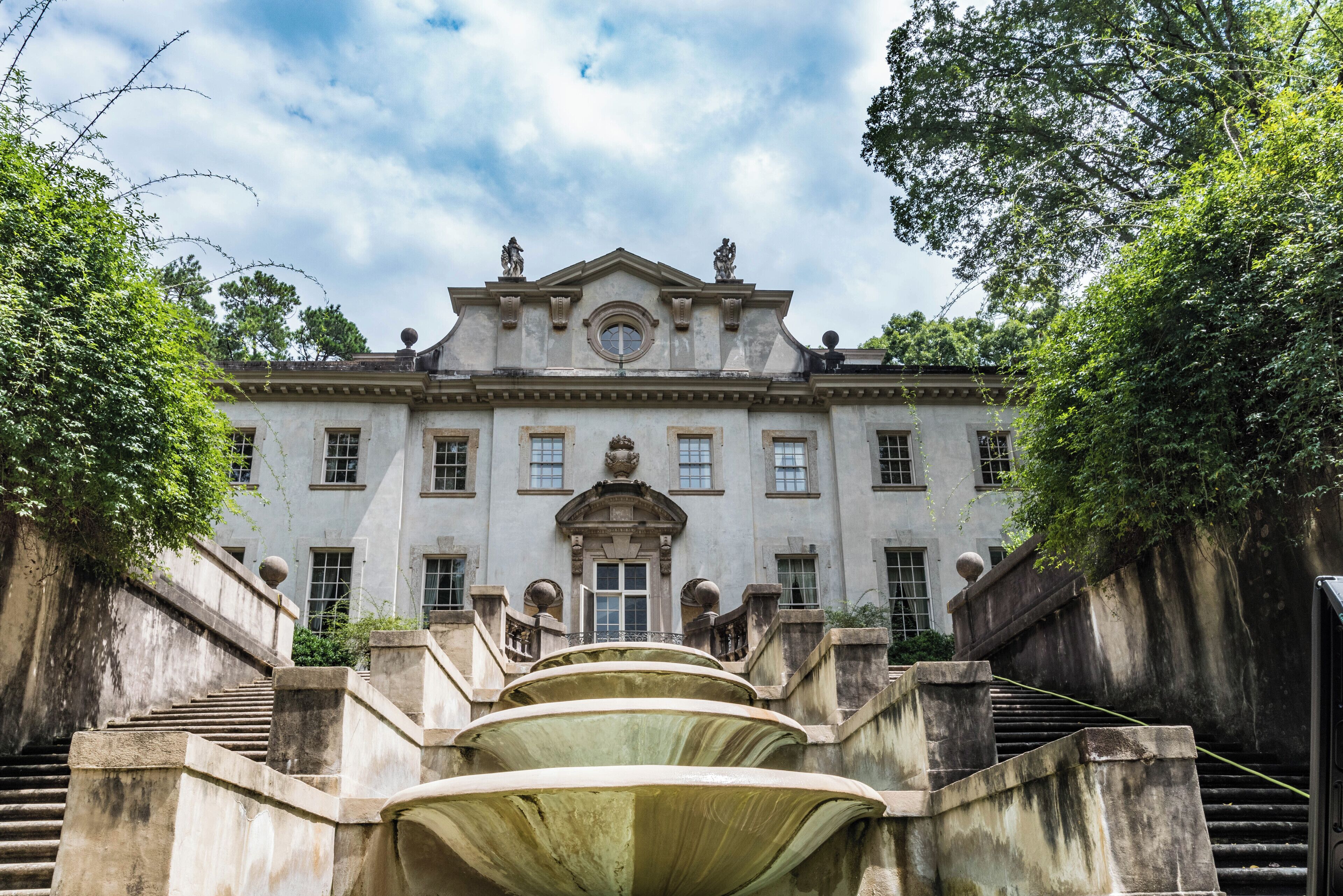 A grand building with a symmetrical facade, large windows, and a central entrance.