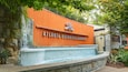The Atlanta Botanical Garden entrance with a stone wall and a water feature.