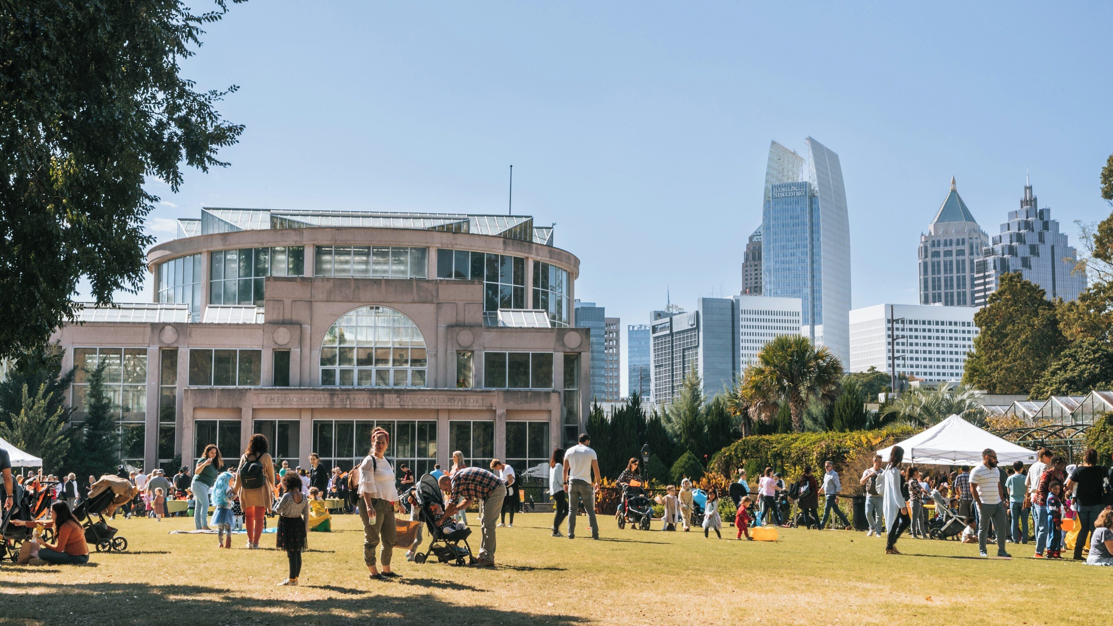 Enjoying a beautiful day at Atlanta Botanical Garden with vibrant activities against the Midtown skyline
