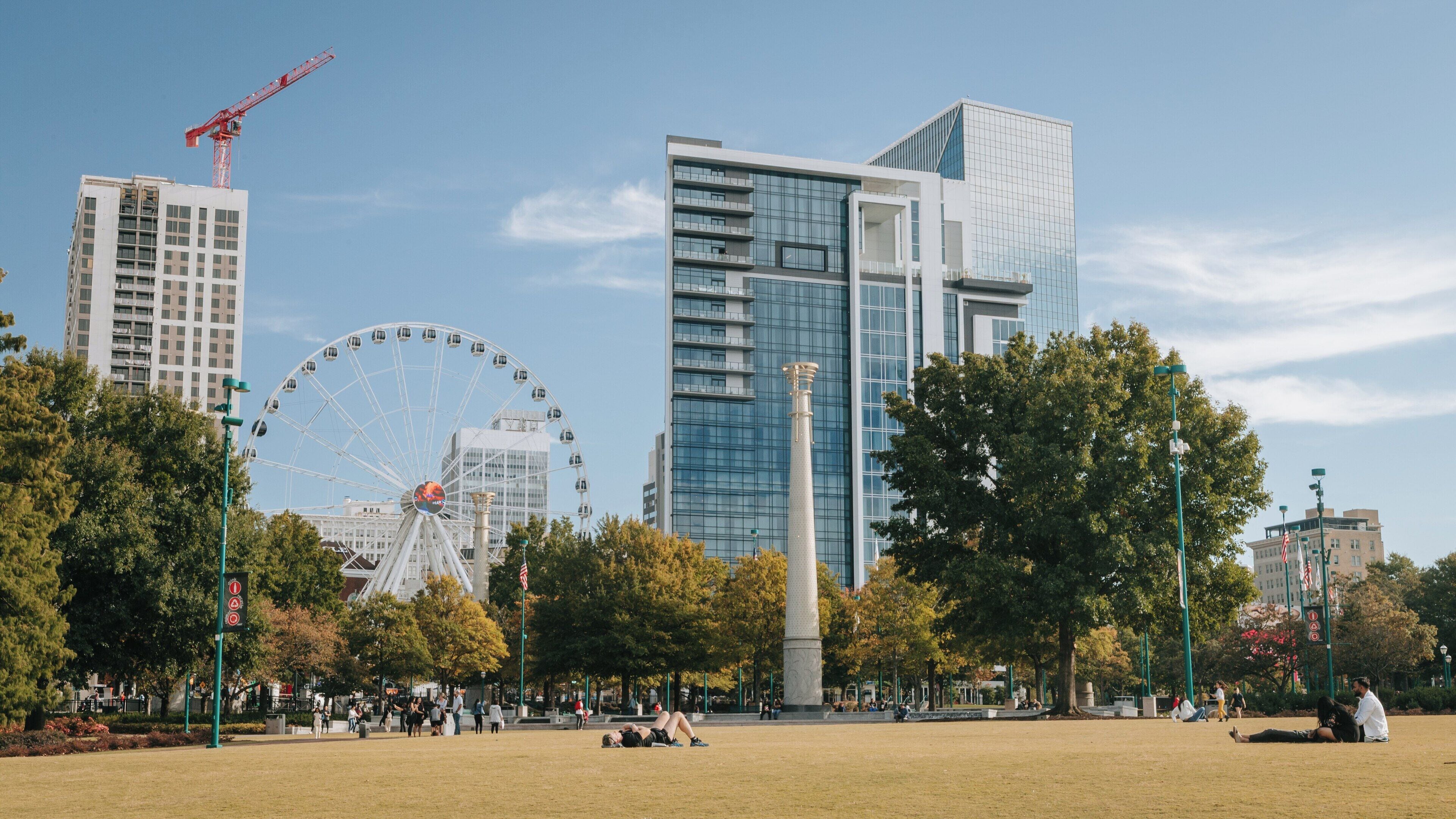 Centennial Olympic Park in Downtown Atlanta showcases vibrant greenery and iconic attractions on a sunny day