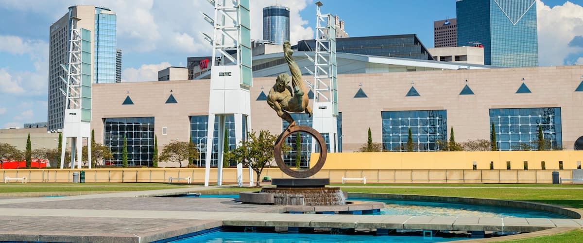 State Farm Arena featuring a fountain, a city and outdoor art