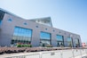 A modern building with large windows and triangular architectural details.