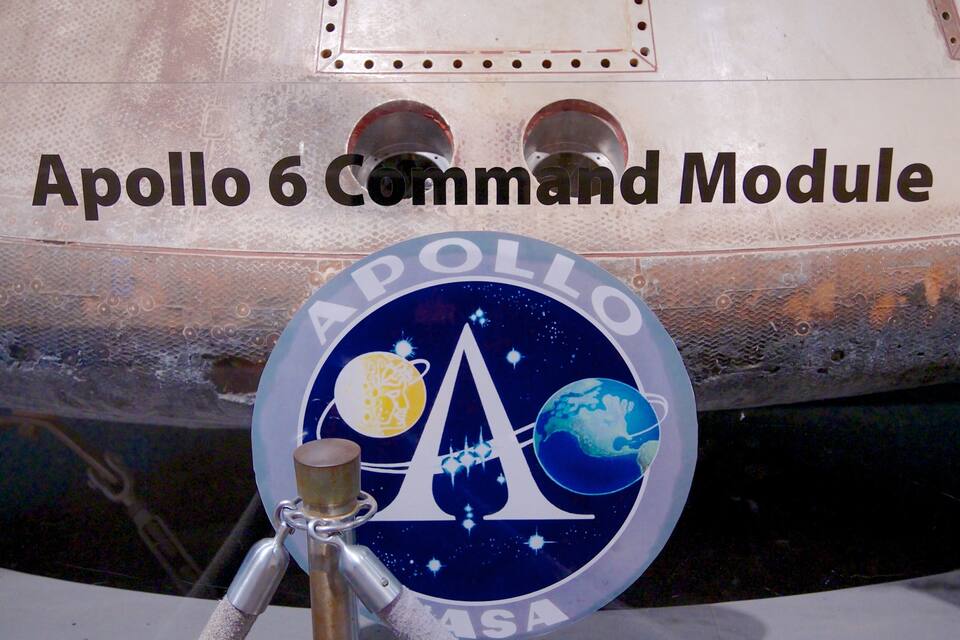 The Apollo 6 Command Module with a space-themed emblem.