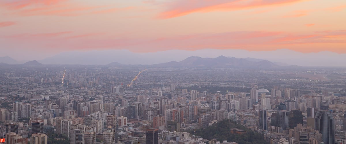 San Cristobal Hill showing a city and a sunset