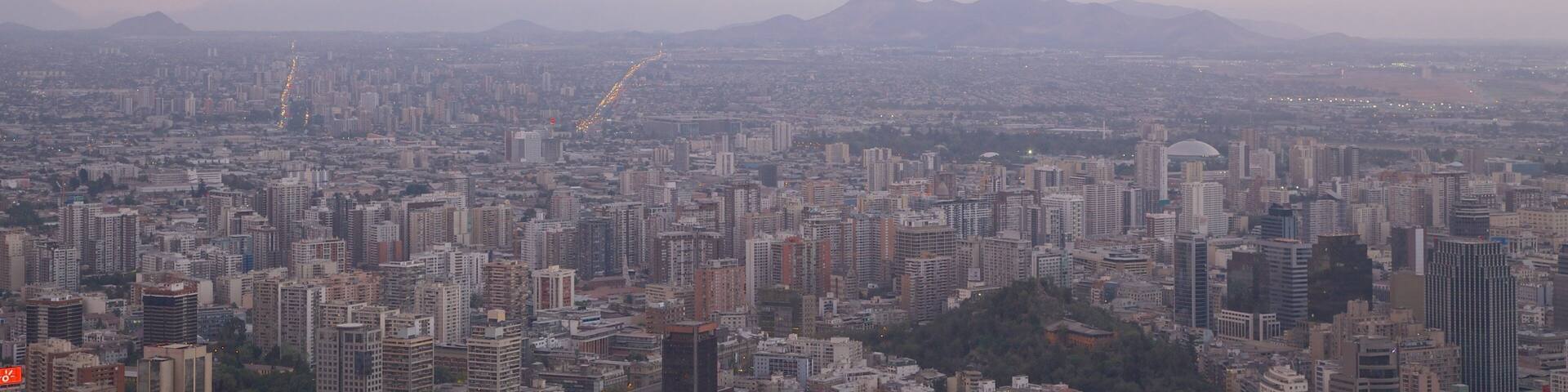 San Cristobal Hill showing a city and a sunset
