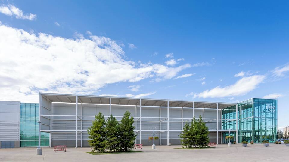A modern building with glass windows and a metal frame structure.