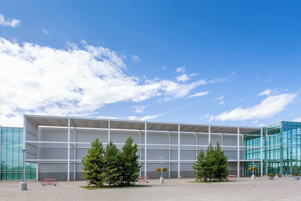A modern building with glass windows and a metal frame structure.