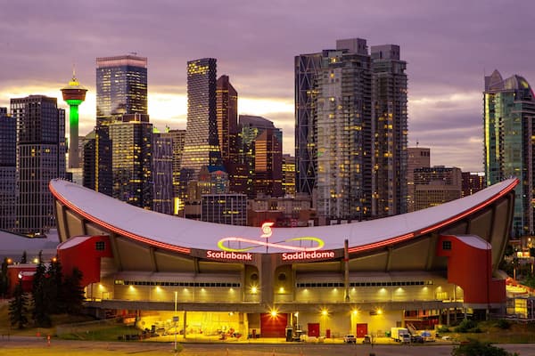 Scotiabank Saddledome which includes a city, a sunset and modern architecture
